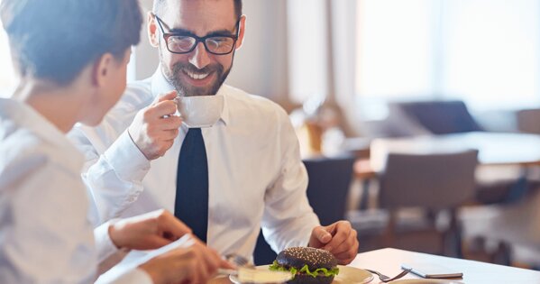 Zwei Personen, die zusammen etwas essen und trinken
